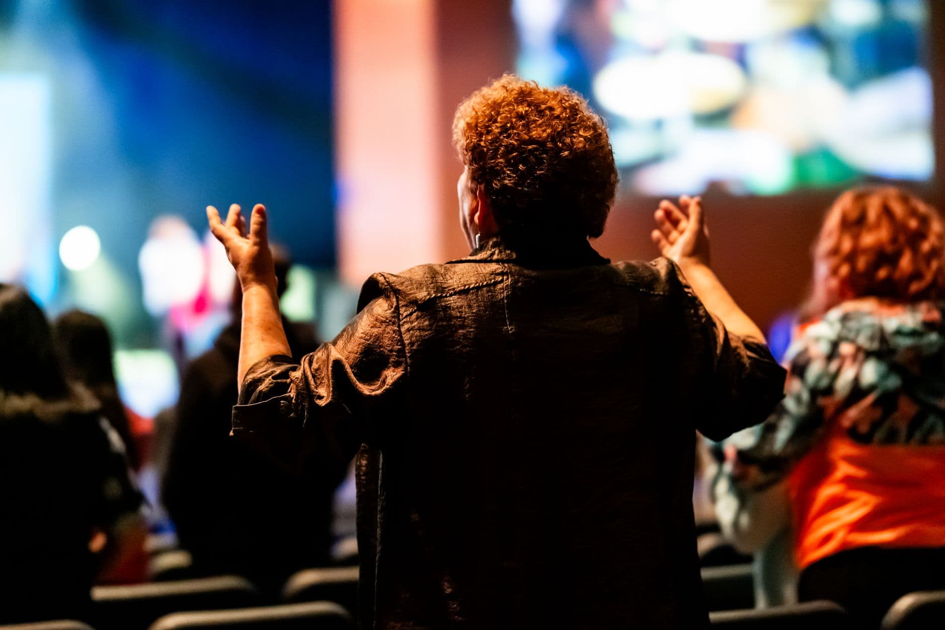 A diverse group of people engaged in a lively spiritual gathering, emotionally involved.